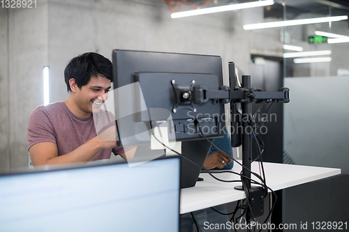 Image of young multiethnics team of software developers working together