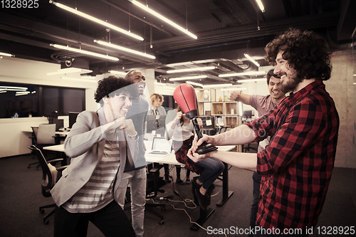 Image of multiethnics business team boxing at office