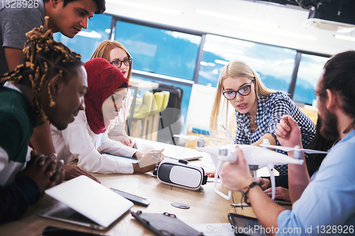 Image of multiethnic business team learning about drone technology