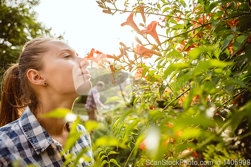 Image of Young and happy farmer\'s couple at their garden in sunny day