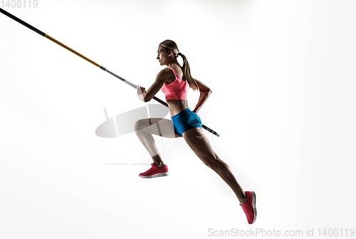 Image of Female pole vaulter training on white studio background