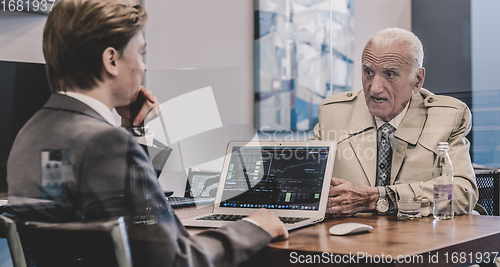 Image of Financial advisor consulting senior client with his investment strategy.