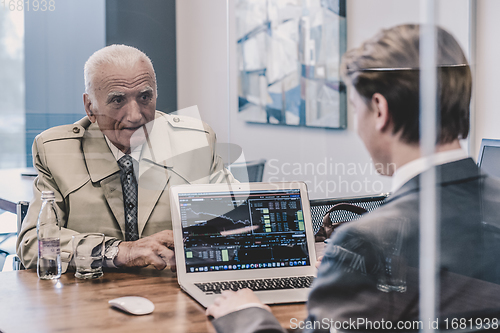 Image of Financial advisor consulting senior client with his investment strategy.