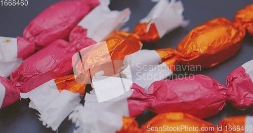 Image of Christmas candy lying on the table with camera in motion closeup