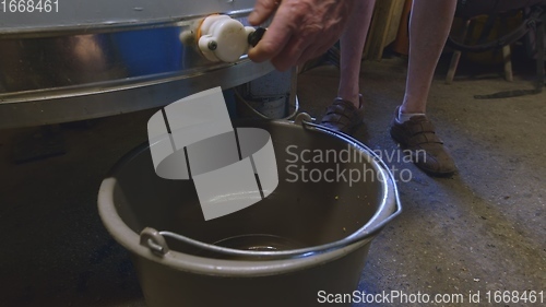 Image of Raw honey pouring out closeup footage