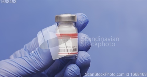 Image of Vaccine in human hands closeup footage