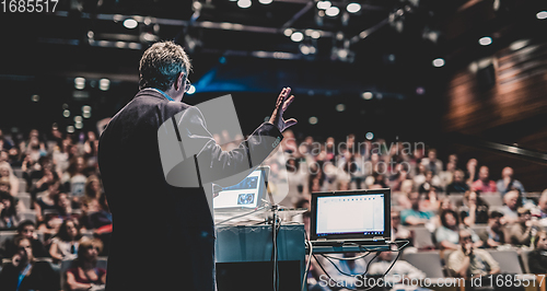 Image of Public speaker giving talk at Business Event.