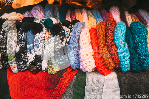 Image of Traditional Christmas Winter Market Trading Houses With Warm Clothes, Wear And Hats. Colorful Knitted Traditional European Warm Clothes - Mittens and Scarfs. Xmas Souvenir From Europe.