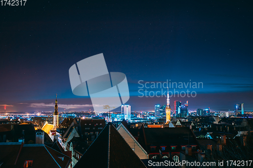 Image of Tallinn, Estonia, Europe. Natural Night Starry Sky Above Tallinn Skyline Cityscape. Old Town And Modern City. Popular Place With Famous Landmarks. UNESCO. Tallinn, Estonia, Europe. Natural Night Star