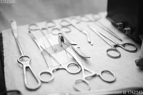 Image of Old medical and surgical instruments. German Deutsch Wehrmacht World War II Times Many Old surgical instruments For surgery. WWII WW2. Black And White. Old medical and surgical instruments. German De