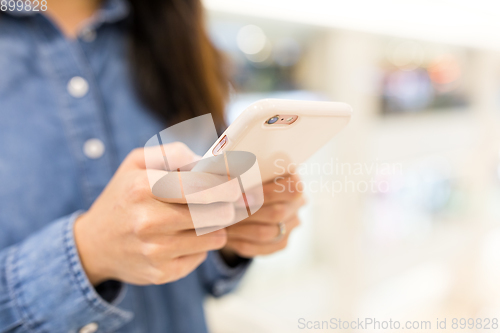 Image of Woman sending sms on mobile phone