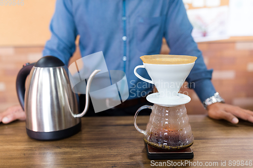 Image of Male Barista making of coffee in cafe