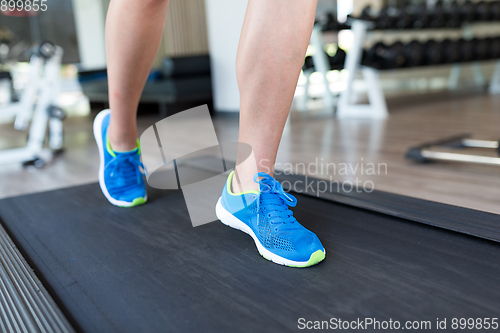 Image of Woman running on treadmill in gym