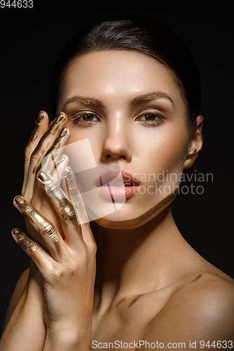 Image of girl with golden paint on fingers