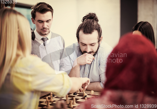 Image of multiethnic group of business people playing chess