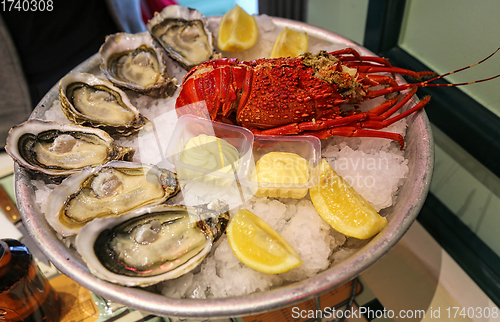 Image of Large dish of fresh seafood, oysters with lobster with lemon and