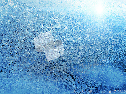 Image of Beautiful ice pattern and sunlight close-up on winter glass