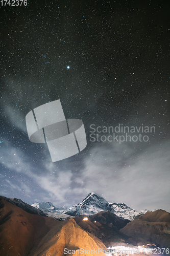 Image of Stepantsminda, Georgia. Night Starry Sky With Glowing Stars Above Peak Of Mount Kazbek Covered With Snow. Night Lightning. Beautiful Georgian Landscape In Late Autumn. Stepantsminda, Georgia. Night S