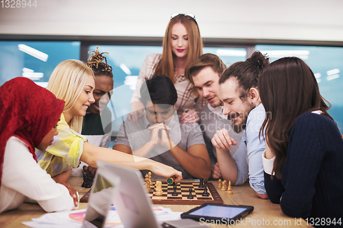 Image of multiethnic group of business people playing chess