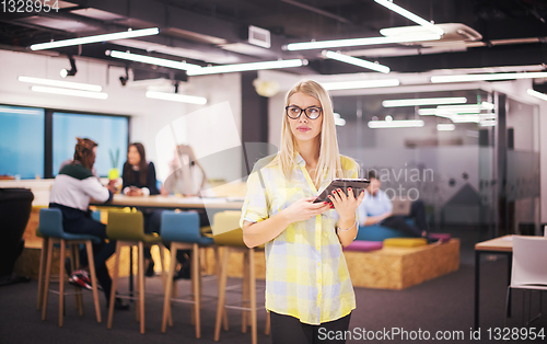 Image of blonde businesswoman working online using digital tablet