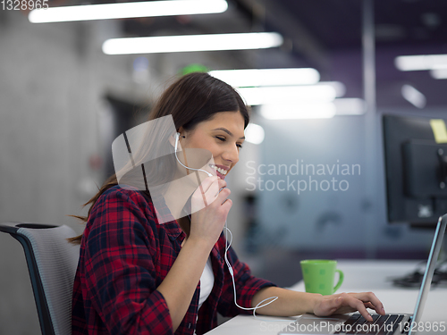 Image of female software developer using laptop computer