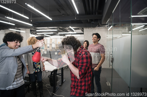 Image of multiethnics business team boxing at office