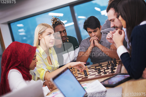 Image of multiethnic group of business people playing chess