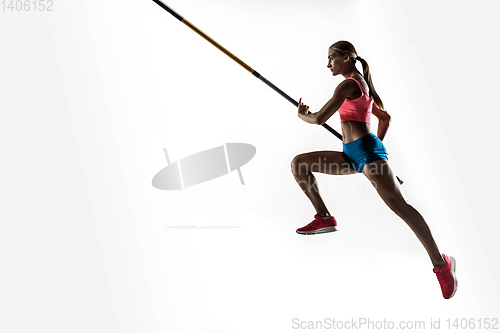 Image of Female pole vaulter training on white studio background