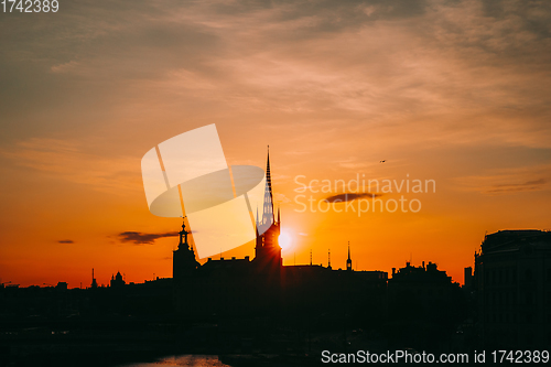 Image of Stockholm, Sweden. Sunset Sun Shine Through Dark Silhouette Of Riddarholm Church In Stockholm Skyline. Scenic View Of Gamla Stan Old Town In Dramatic Sunshine Sunlight. Popular Destination Scenic