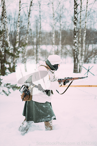 Image of German Wehrmacht Infantry Soldier In World War II Attacking With Rifle In Winter Day. Historical Re-enactment. WWII.