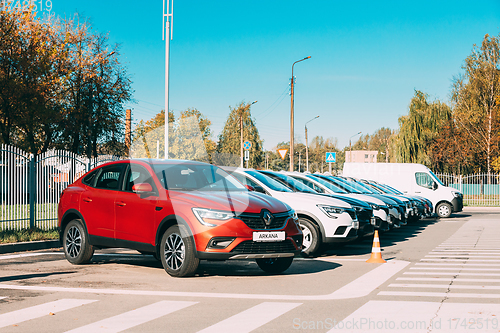 Image of Different Renault Cars Arkana And Kaptur parking in row outdoors. Subcompact Crossovers Produced Jointly By Renault Nissan Alliance. Cars Parked Near Dealership.