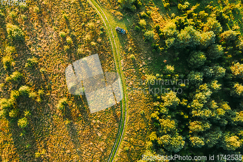 Image of Aerial View Of Car Near Country Road Thgrough Forest And Green Meadow Landscape In Sunny Summer Morning. Top View Of Beautiful European Nature From High Attitude