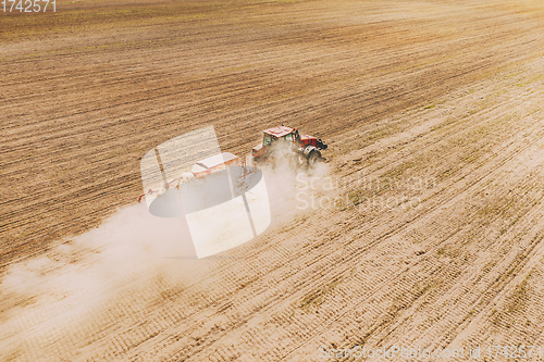 Image of Aerial View. Tractor With Seed Drill Machine Sowing The Seeds For Crops In Spring Season. Beginning Of Agricultural Spring Season. Countryside Rural Field Landscape