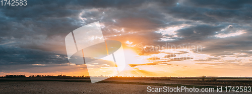 Image of Sun Shine During Sunset Above Empty Spring Countryside Rural Soil Landscape. Field Under Sunny Spring Sky. Agricultural Landscape With Copy Space. Panorama