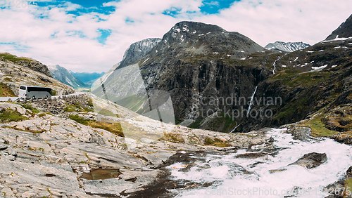 Image of Trollstigen, Andalsnes, Norway. Bus Goes On Road Near Stigfossen Waterfall. Famous Mountain Road Trollstigen. Norwegian Landmark And Popular Destination. Norwegian County Road 63 In Sunny Summer Day