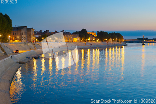 Image of People walking embankment Arles, France