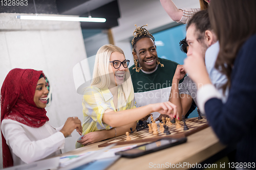 Image of multiethnic group of business people playing chess