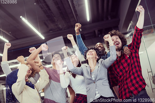 Image of portrait of young excited multiethnics business team