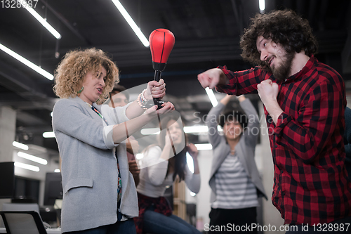 Image of multiethnics business team boxing at office