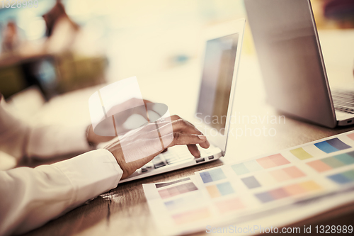 Image of black muslim business woman ,working on laptop computer
