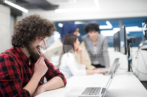 Image of young multiethnics team of software developers working together