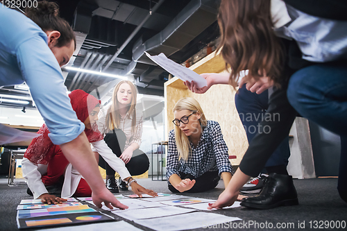 Image of blonde businesswoman having meeting with Multiethnic  startup bu