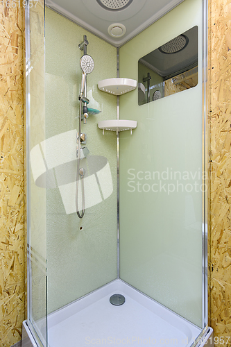 Image of Shower stall with cracked glass, located in a country house