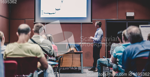 Image of Business speaker giving talk at business conference event.