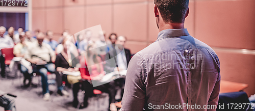 Image of Public speaker giving talk at Business Event.