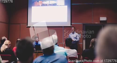 Image of Business speaker giving talk at business conference event.