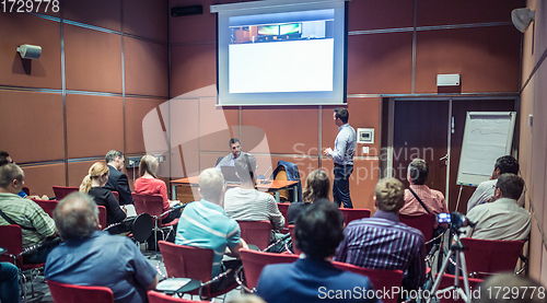 Image of Business speaker giving talk at business conference event.