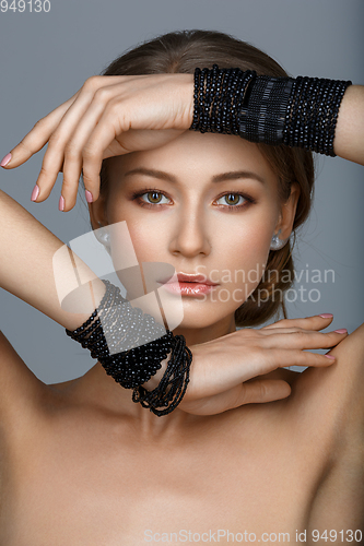 Image of beautiful girl with many black bracelts