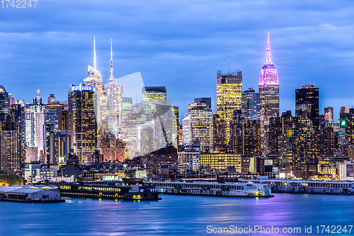 Image of West New York City midtown Manhattan skyline view from Boulevard East Old Glory Park over Hudson River at dusk.