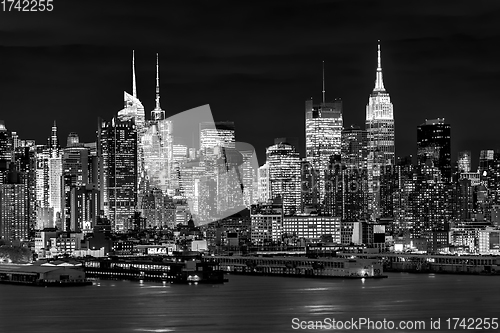 Image of West New York City midtown Manhattan skyline view from Boulevard East Old Glory Park over Hudson River at dusk.